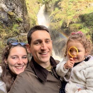 Mike Carter standing with his family in front of a waterfall