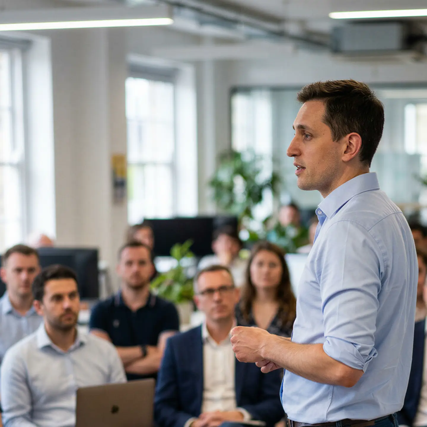 Mike Carter talking to a group of people in an office environment